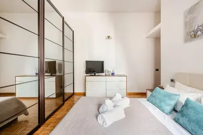 a living room with a white couch and a tv at Suite Testaccio in Rome