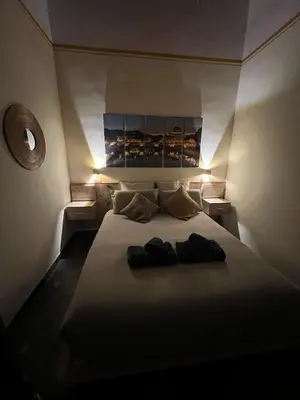 a bedroom with a bed with two pairs of shoes on it at S Angelo Apartment in Rome