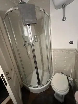 a bathroom with a shower and a toilet at S Angelo Apartment in Rome