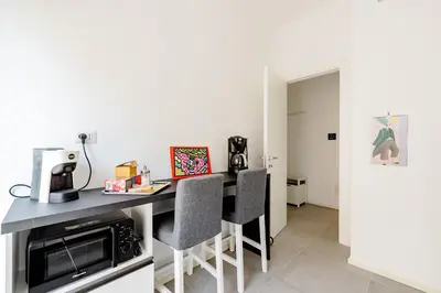a kitchen with a table and two chairs at Appartamento Moderno-H2OME nuovo in Rome