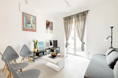 a white living room with a couch and chairs at Appartamento Moderno-H2OME nuovo in Rome
