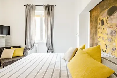 a bedroom with a large bed with yellow pillows at Appartamento Moderno-H2OME nuovo in Rome