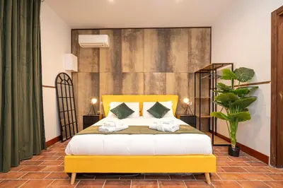 a bedroom with a yellow bed with towels on it at Trastevere 1 in Rome
