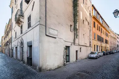 an alley with cars parked on the side of a building at Trastevere 1 in Rome