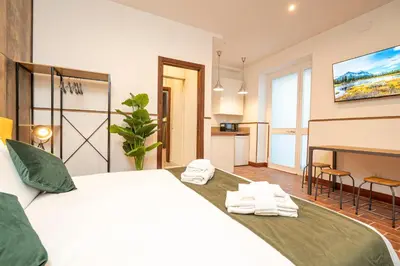 a bedroom with a large white bed with towels on it at Trastevere 1 in Rome