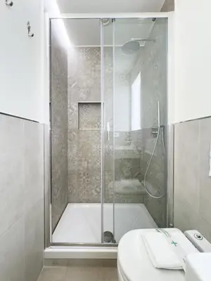 a bathroom with a shower and a toilet and a sink at Gold Suite 5 minuti dal Colosseo in Rome