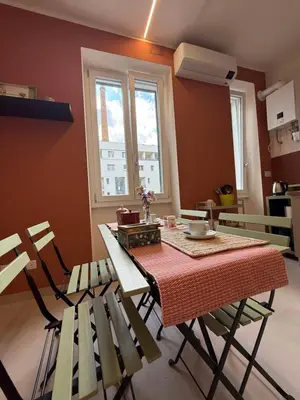 a dining room with a table and chairs and a window at Casa dei Parchi in Rome