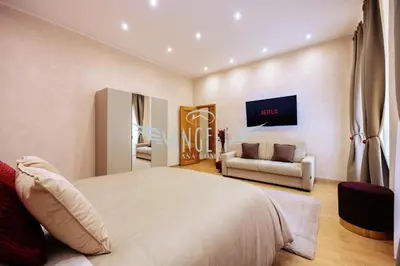a bedroom with a large bed and a couch at BlueHouse Roma, ampia casa per gruppi e famiglie in Rome