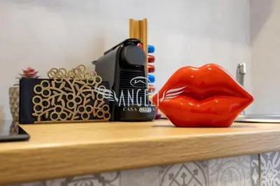 a phone and a red mouth on a shelf at BlueHouse Roma, ampia casa per gruppi e famiglie in Rome