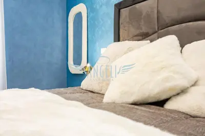 a bed with white pillows on top of it at BlueHouse Roma, ampia casa per gruppi e famiglie in Rome