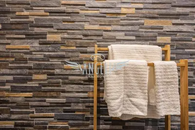 a towel rack in front of a brick wall at BlueHouse Roma, ampia casa per gruppi e famiglie in Rome