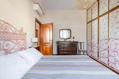 a bedroom with a large bed and a dresser at Roman Retreat Near the Appian Way & Catacombs in Rome