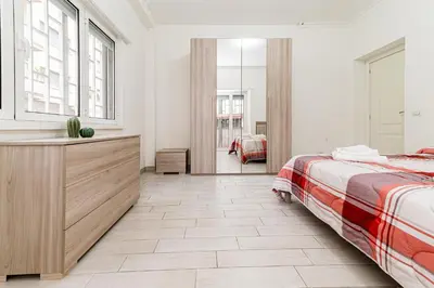 a bedroom with a bed and a dresser and window at A Casa di Federico e Nikki - Vatican City - Metro Baldo degli Ubaldi in Rome