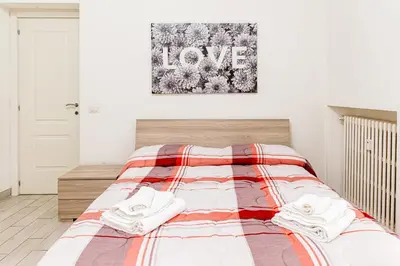 a bedroom with a bed with two towels on it at A Casa di Federico e Nikki - Vatican City - Metro Baldo degli Ubaldi in Rome