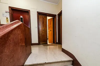 an empty hallway with two doors and a staircase at A Casa di Federico e Nikki - Vatican City - Metro Baldo degli Ubaldi in Rome