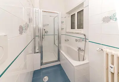 a white bathroom with a shower and a sink at A Casa di Federico e Nikki - Vatican City - Metro Baldo degli Ubaldi in Rome