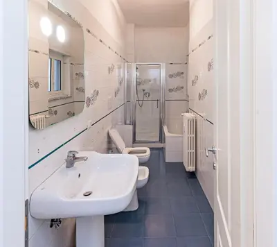 a bathroom with a sink and two toilets at A Casa di Federico e Nikki - Vatican City - Metro Baldo degli Ubaldi in Rome