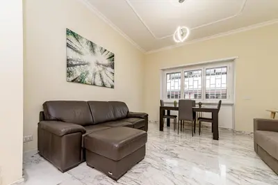 a living room with a couch and a table at A Casa di Federico e Nikki - Vatican City - Metro Baldo degli Ubaldi in Rome