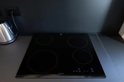 a black stove top oven sitting on top of a counter at Courtyard Doria Comfort & Style at Vatican Museums in Rome