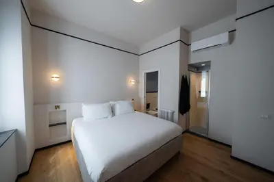 a bedroom with a large white bed in a room at Courtyard Doria Comfort & Style at Vatican Museums in Rome