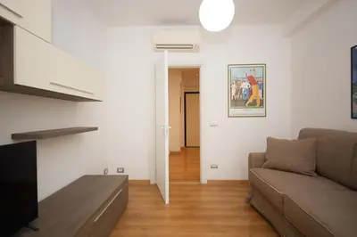 a living room with a couch and a tv at Maison Tiburtina by Ghor in Rome