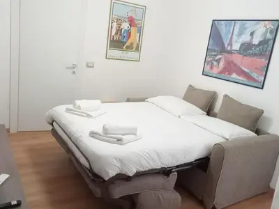a bedroom with a bed and a couch in it at Maison Tiburtina by Ghor in Rome
