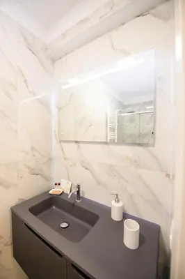 a bathroom with a sink and a mirror at Boncompagni Serenity Suites in Rome
