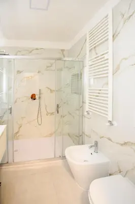 a bathroom with a shower and a sink and a toilet at Boncompagni Serenity Suites in Rome