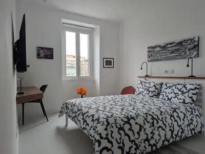 a bedroom with a bed and a desk and a window at Ostiense 353 Apartment by RS in Rome