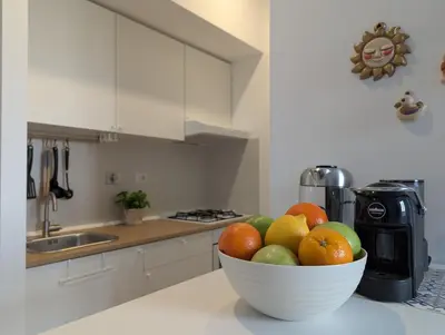 a bowl of fruit on a counter in a kitchen at Ostiense 353 Apartment by RS in Rome