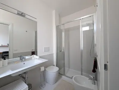 a bathroom with a shower and a sink and a toilet at Ostiense 353 Apartment by RS in Rome