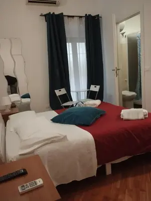 a bedroom with a large bed with a red blanket at Bilocale privato in Rome