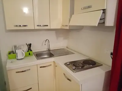 a small kitchen with white cabinets and a sink at Bilocale privato in Rome
