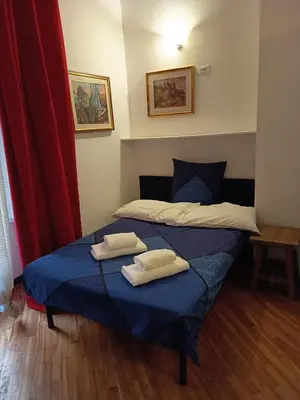 a bedroom with a bed with two towels on it at Bilocale privato in Rome
