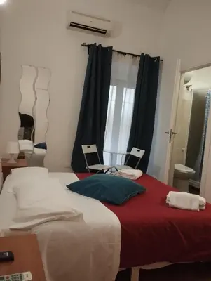a bedroom with a large bed with a red blanket at Bilocale privato in Rome