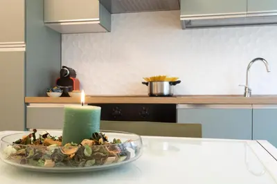 a candle on a plate on a kitchen counter at Vigna Clara apartment in Rome