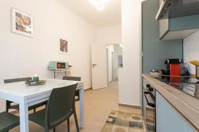 a kitchen and dining room with a white table and chairs at Vigna Clara apartment in Rome