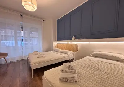 a bedroom with two beds and a window at RHome 34 in Rome