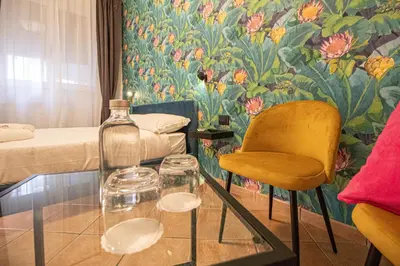 a room with a glass table and a bottle and a chair at RHome 34 in Rome