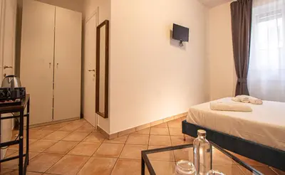 a hotel room with a bed and a glass table at RHome 34 in Rome