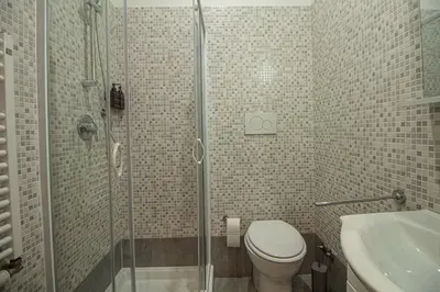 a bathroom with a shower and a toilet and a sink at RHome 34 in Rome