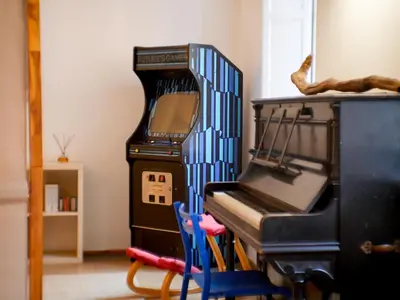a room with a piano and a table and a mirror at Pop Apartment in the Heart of Trastevere 4 Guests in Rome