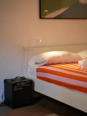 a bedroom with a bed with a pillow and a lamp at Pop Apartment in the Heart of Trastevere 4 Guests in Rome