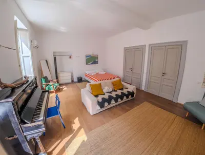a living room with a couch and a bed at Pop Apartment in the Heart of Trastevere 4 Guests in Rome