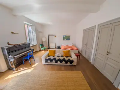 a living room with a piano and a couch at Pop Apartment in the Heart of Trastevere 4 Guests in Rome