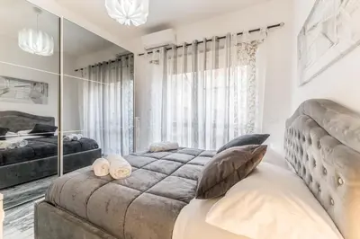 a bedroom with a large bed and a large mirror at Asinari Retreat in Rome