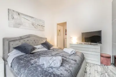 a bedroom with a bed with two towels on it at Asinari Retreat in Rome