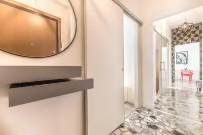a mirror hanging on a wall in a hallway at Asinari Retreat in Rome
