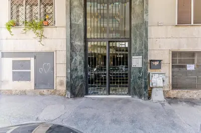 a store front with glass doors on a building at Asinari Retreat in Rome