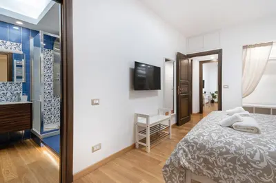 a bedroom with a bed and a mirror at Your Place in Rome Apartments in Rome